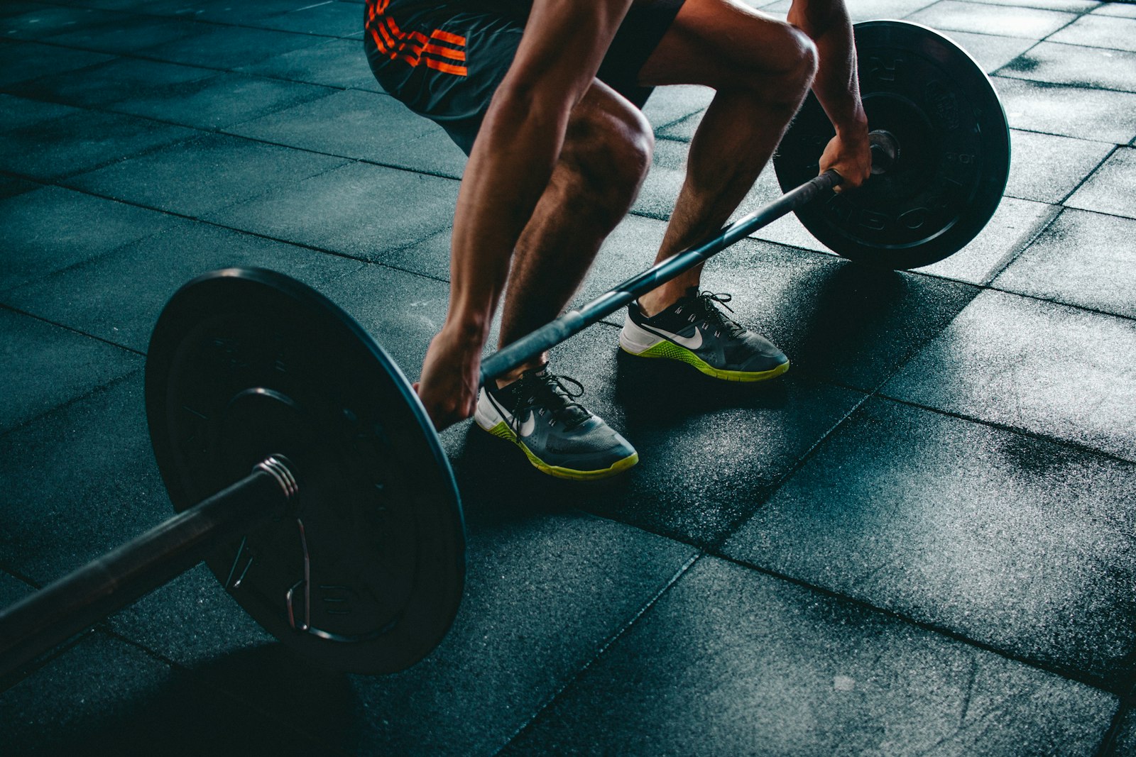 A barbell lift on a rubber gym floor