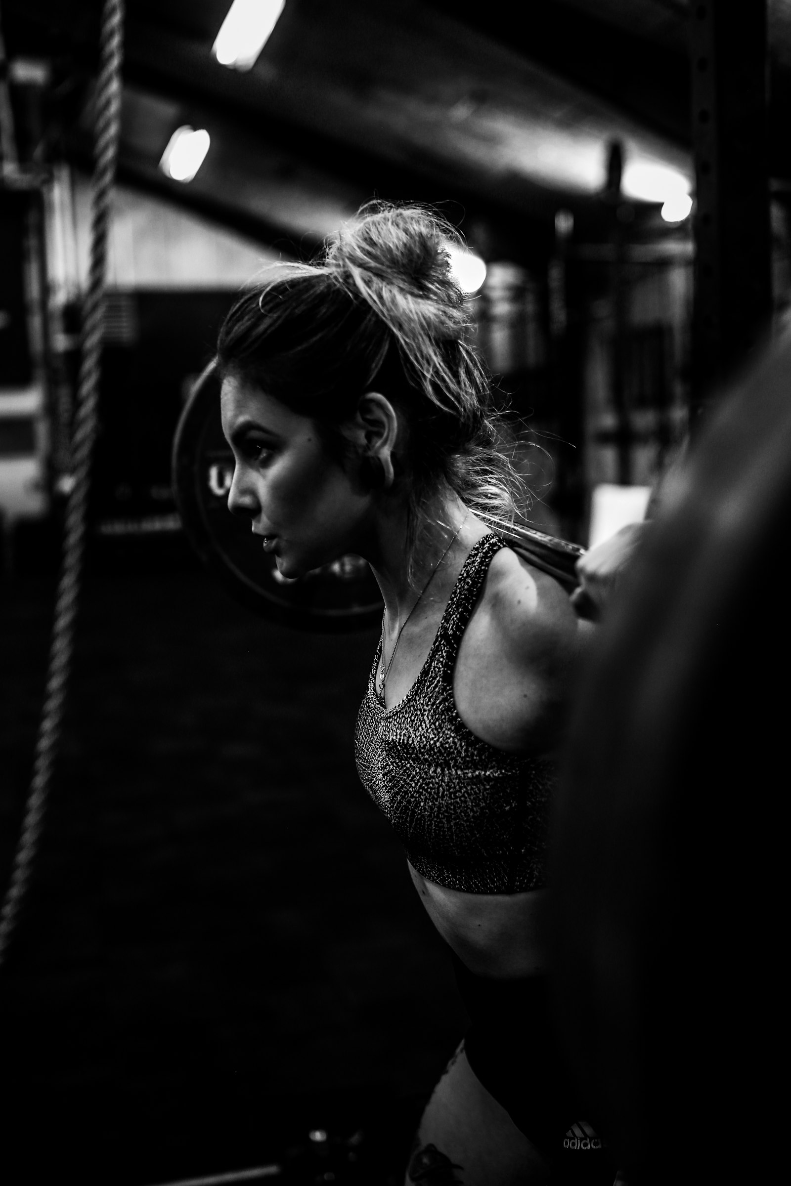 A member training with a barbell in a gym